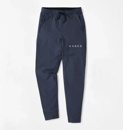 Front view of Kaged x UNRL Apex Training Pants in navy, tapered fit with drawstring waist and side pockets on white background #color_navy