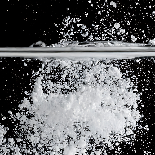 Promotional banner reading Patented 100 percent Soluble Creatine Monohydrate with creatine powder dissolving in water