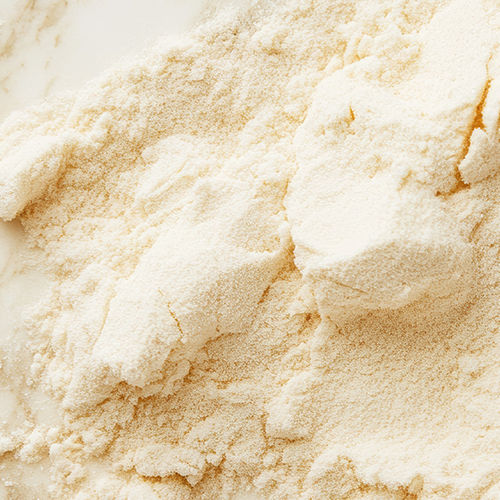 Close-up of Kaged whey protein isolate powder showcasing fine, fluffy texture on a light marble background